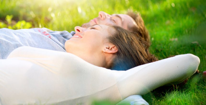 Young Couple Lying on Grass Outdoor